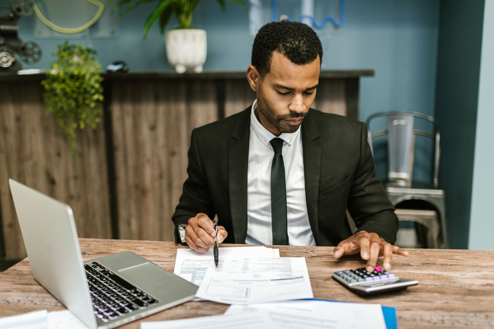 A professional reviewing documents at an office desk.