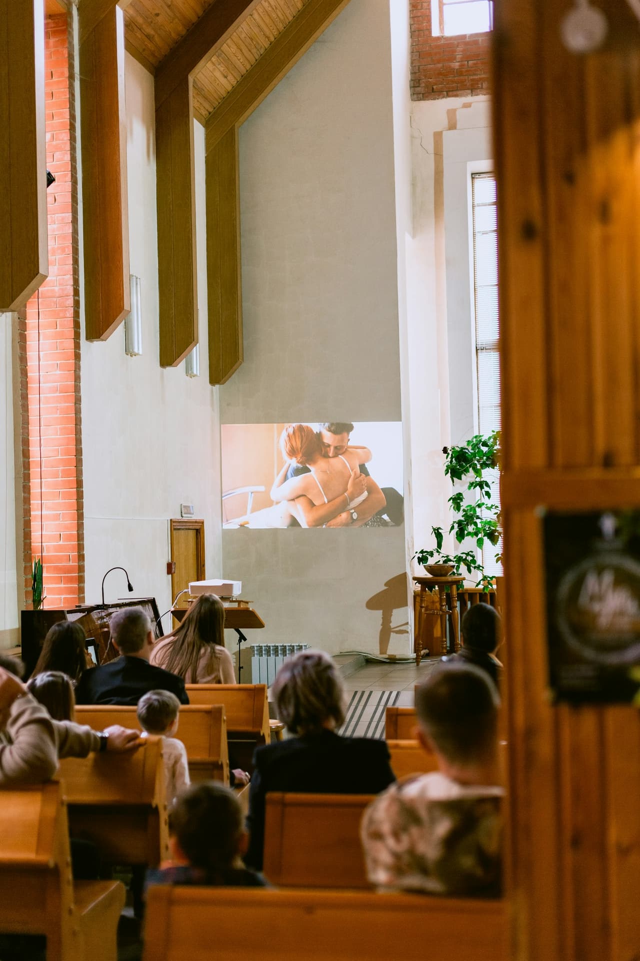 A multigenerational congregation gathered together in a bright faith-community setting.