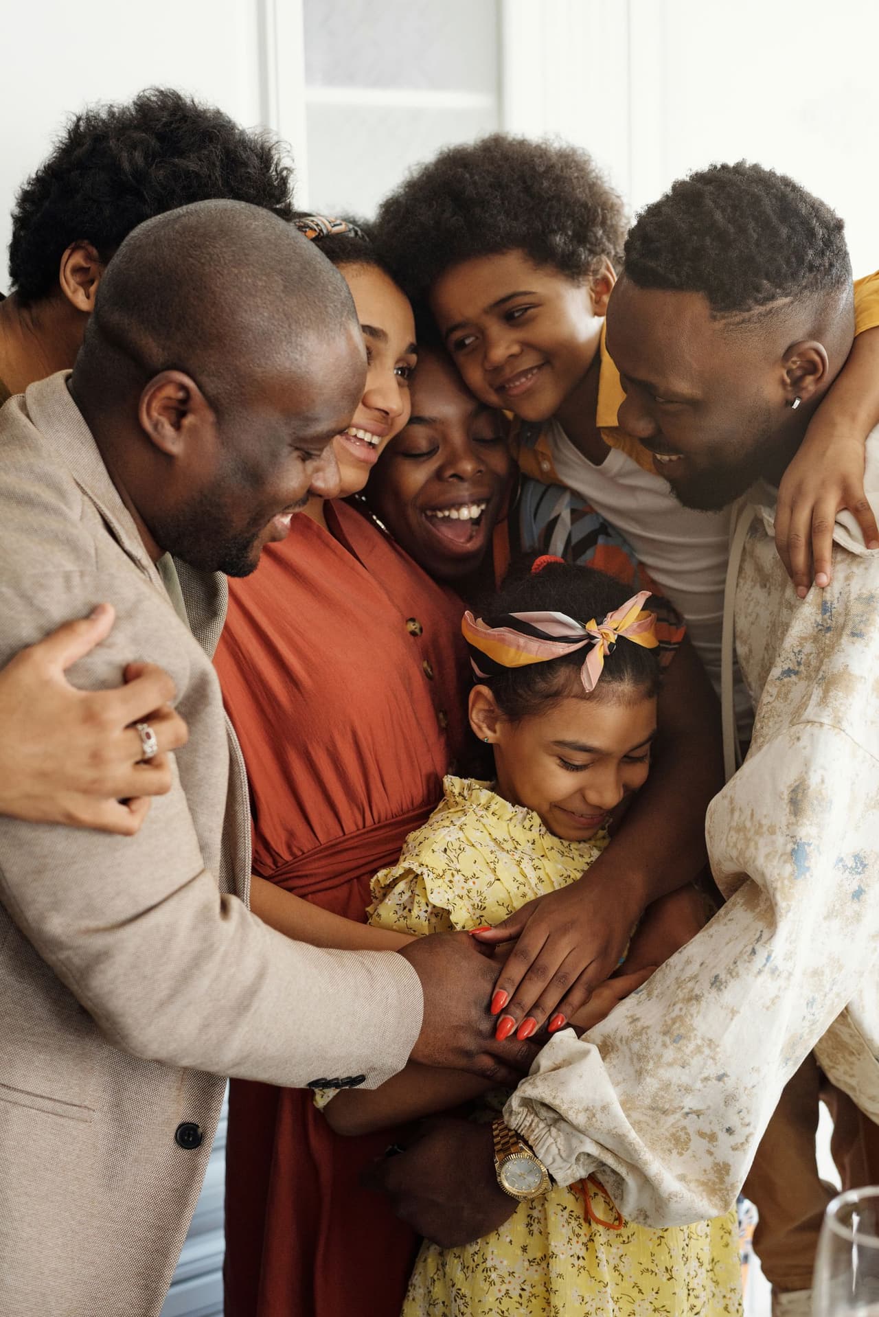 A multi-generational Black family gathered together at home.